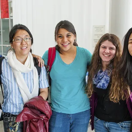 A group of smiling students posing in the Campus Center